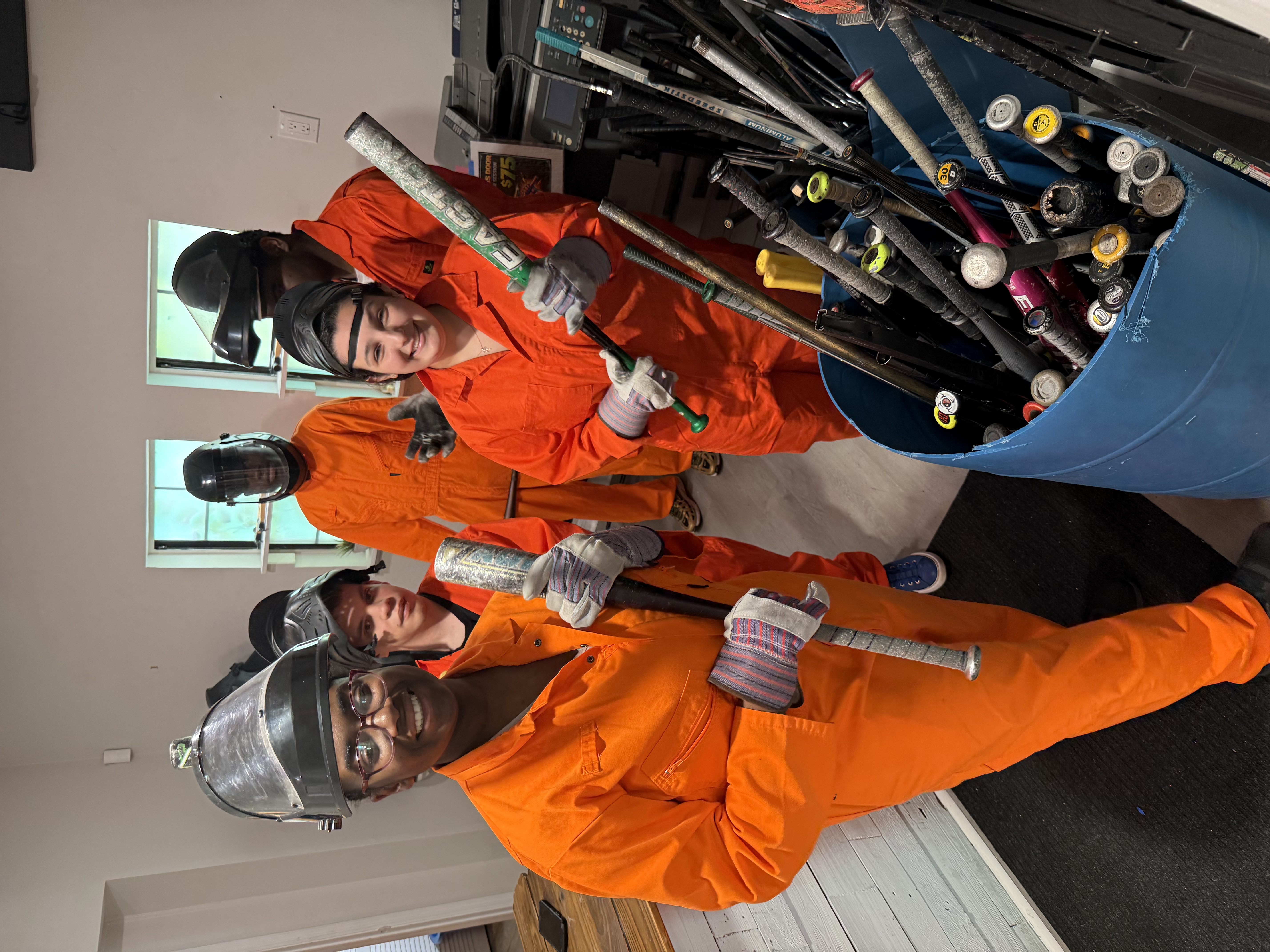 Customers selecting bats from the weapon barrel at Crash Out Rage Rooms
